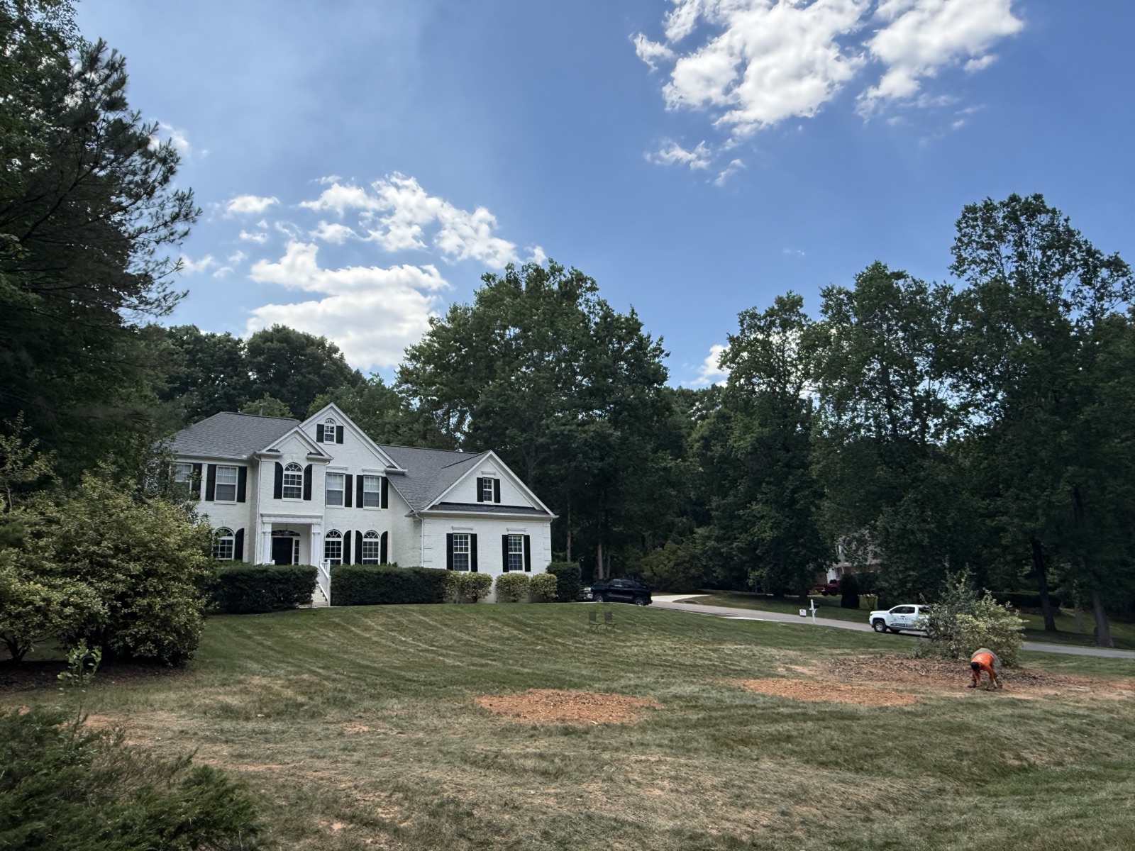 A well kept home in Raleigh with mature trees cared for by Oak City Tree Services